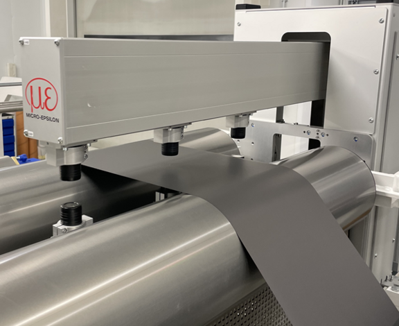 thicknessCONTROL system extended over the calendered material for measurement of thickness